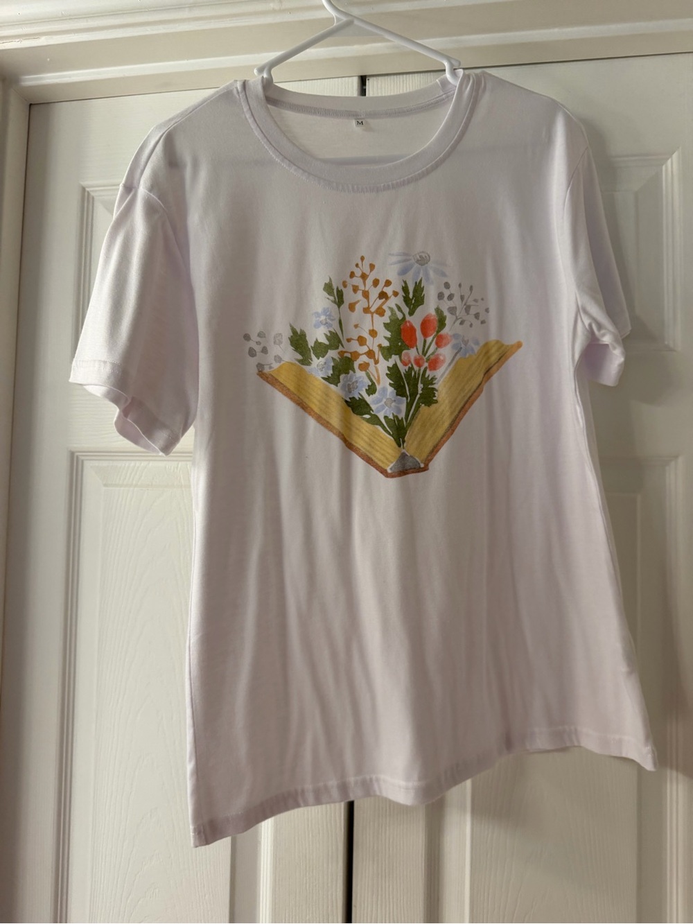 White Graphic T-Shirt with Floral Book Design